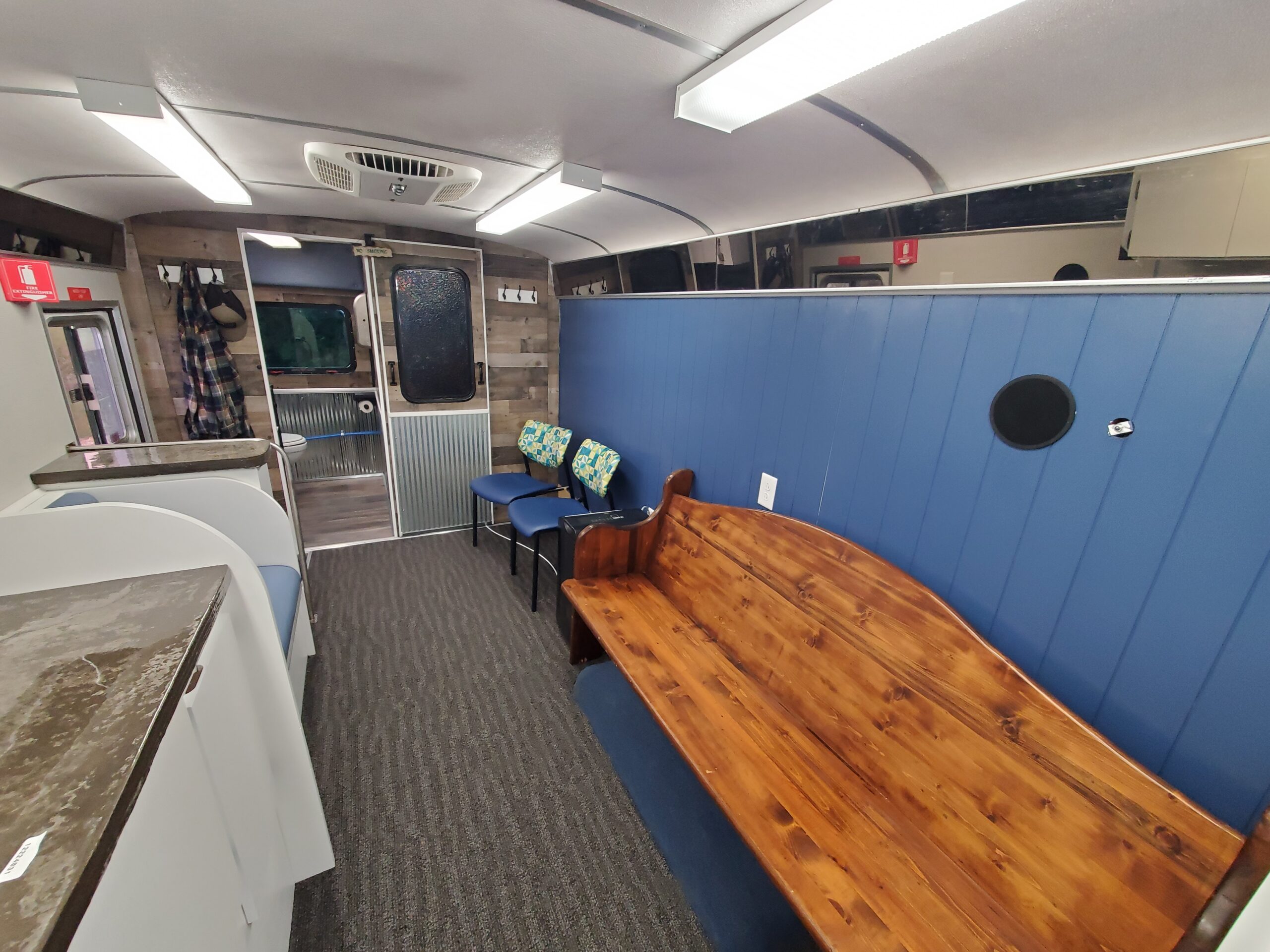 Mobile clinic treatment area with seating and medical equipment